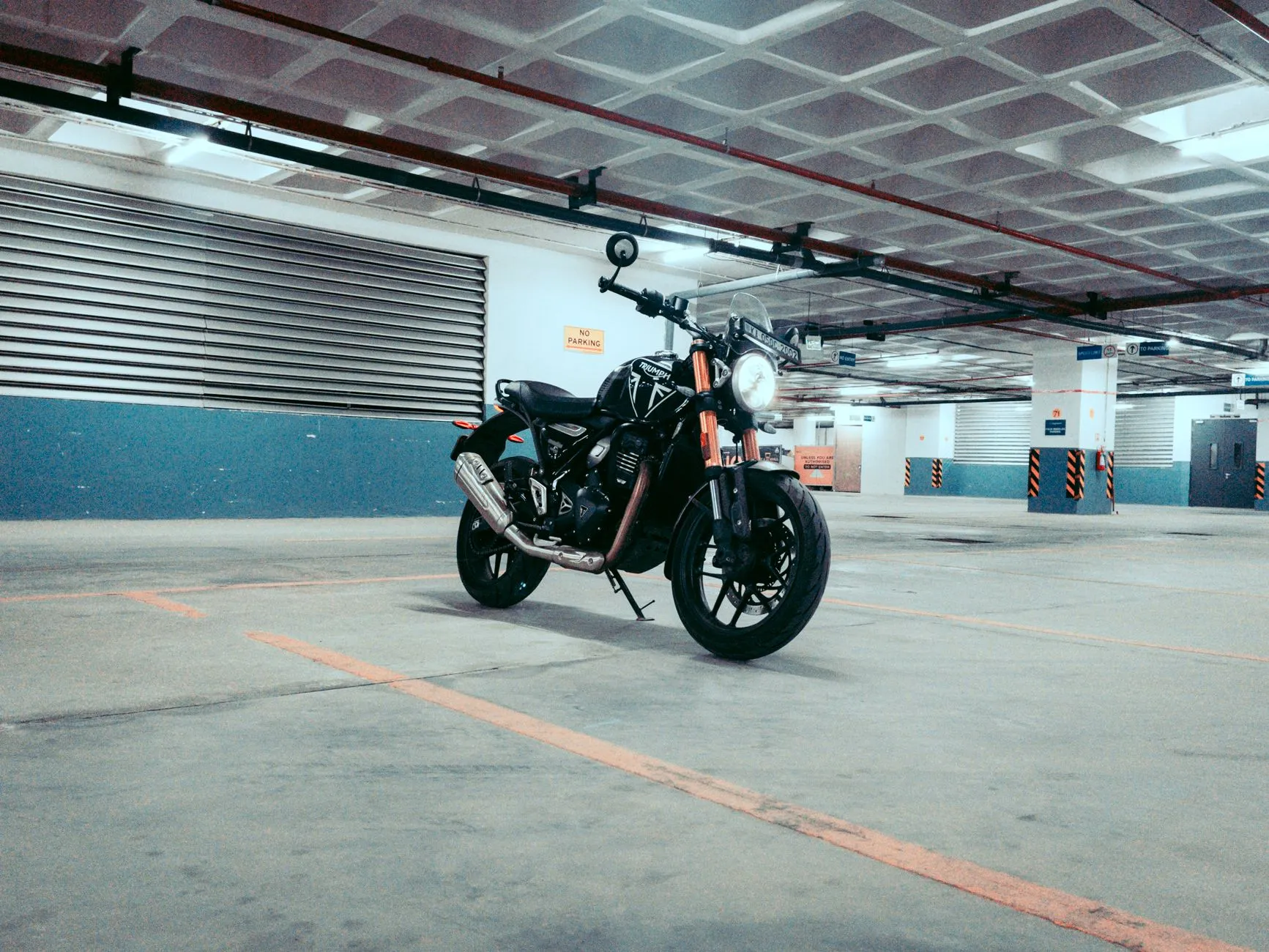 motorcycle parked in parking lot with bar end mirrors