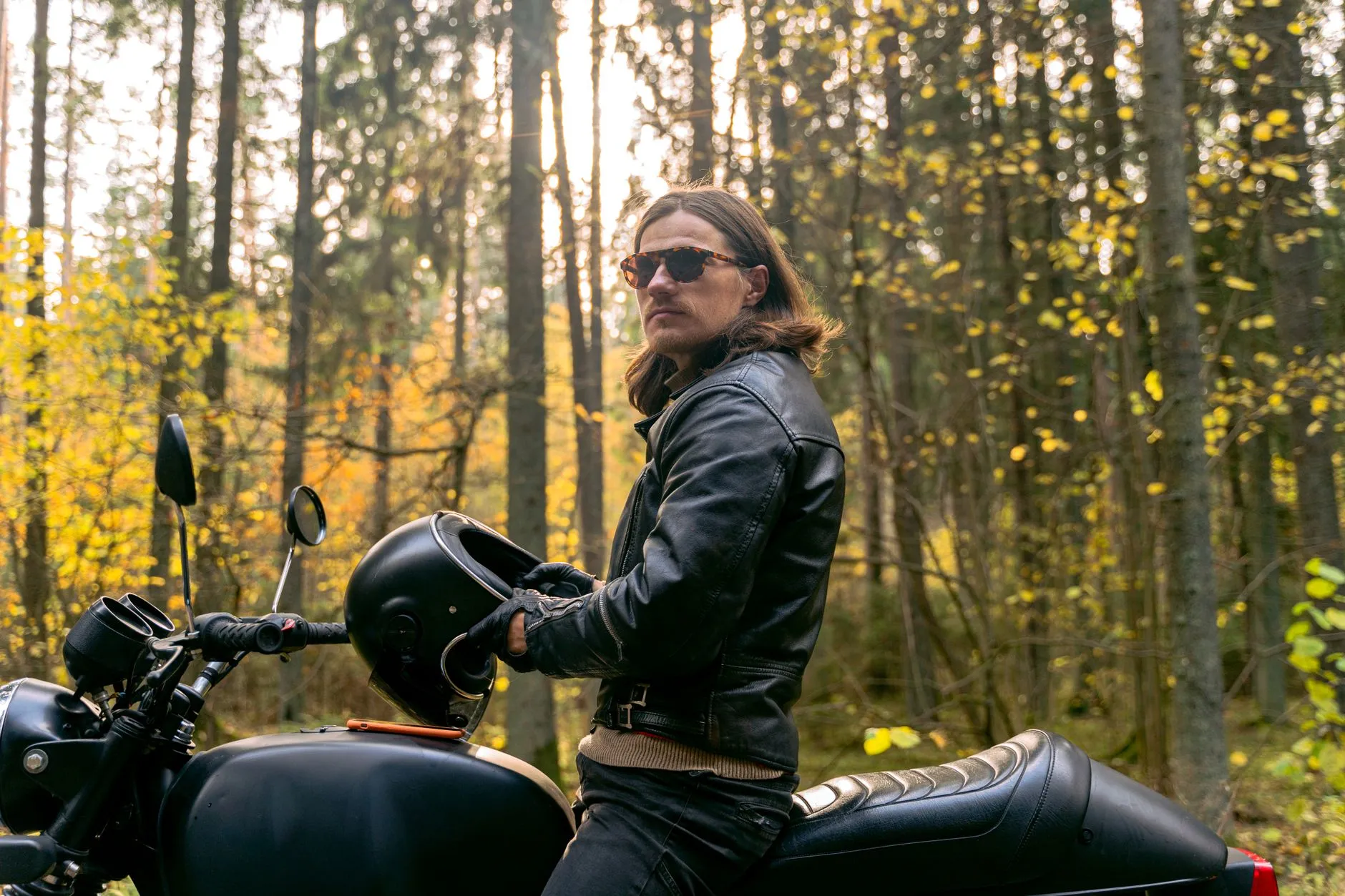 biker adjusting leather riding jacket gear