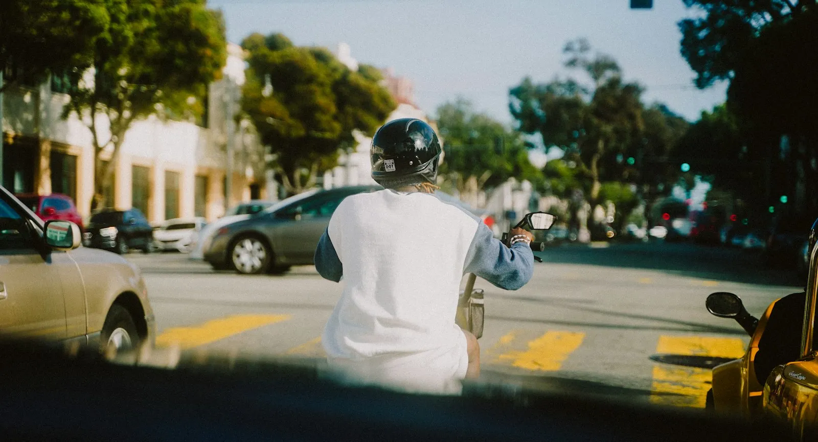 motorcycle rider signaling with hand in traffic