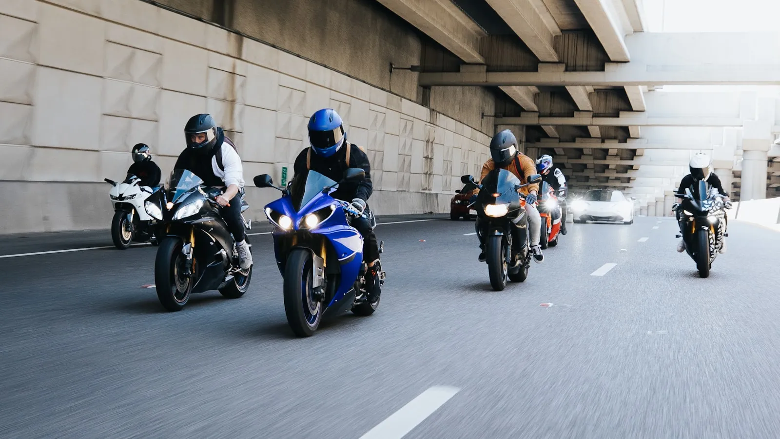 motorcycle group riding together on scenic highway