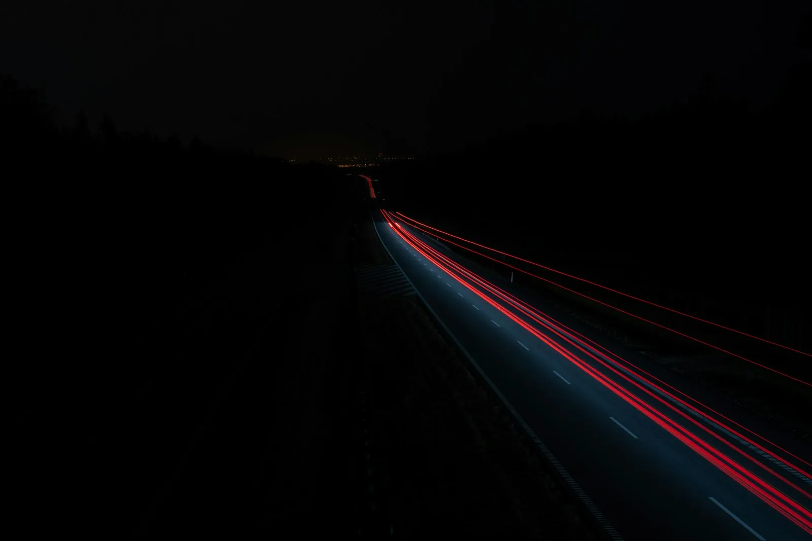 motorcycle headlight beam on dark road